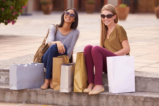 Going shopping with my girl...Two attractive young woman with their shopping bags after a day of retail therapy.