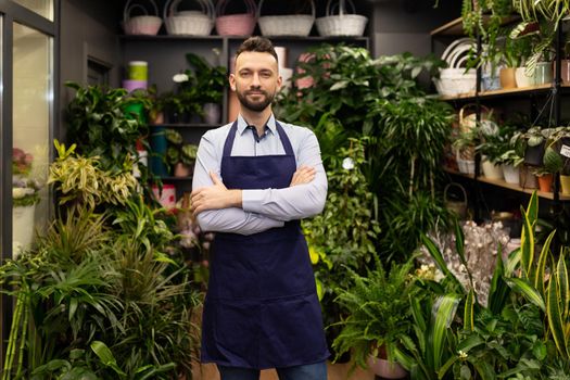 successful entrepreneur male florist on the background of a flower shop