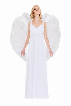Heavenly bliss. Studio shot of a young woman in angel wings isolated on white.