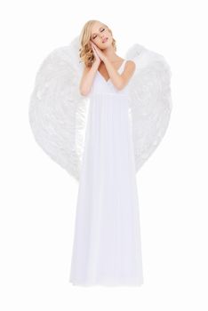 Sweetly innocent. Studio shot of a young woman in angel wings isolated on white.