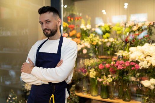 experienced florist next to the refrigerator with bouquets of flowers
