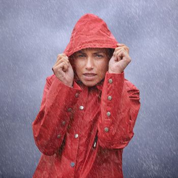 Brrrr....its freezing out here...I wish I had an umbrella. an attractive young woman standing in the rain.