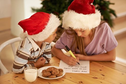 Dear Father Christmas...a young brother and sister writing a letter to Santa.