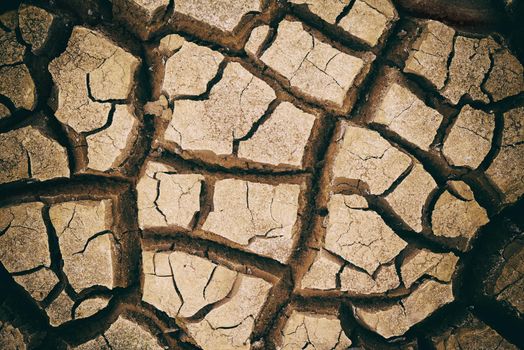 Cracked by the summer heat. Dry cracked ground in the African landscape.