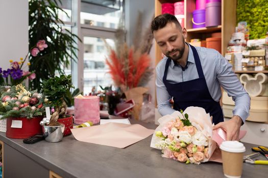 florist entrepreneur prepares a bouquet for sale for Valentine's Day