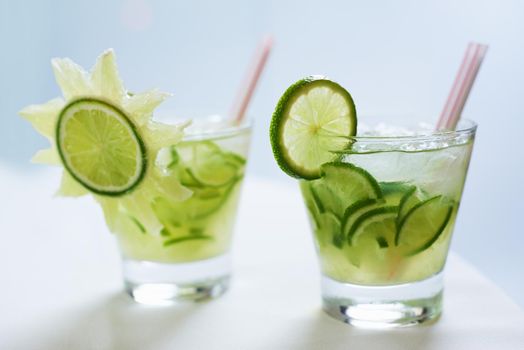 The perfect summer refresher. Two beverages in glasses decorated with cucumbers.