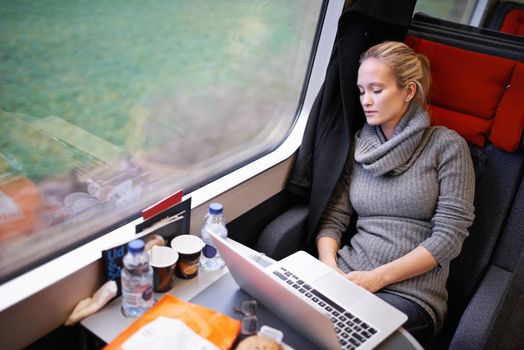 So much space to relax. an attractive young woman traveling by train.