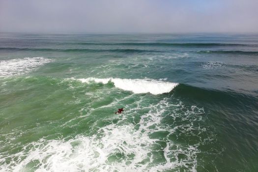 Surfer in the wavy sea