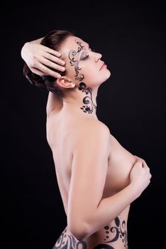 Pretty nude young woman with art makeup