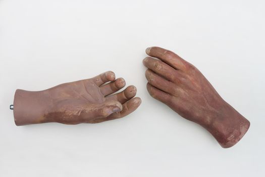 Hands of plastic mannequin on white background.