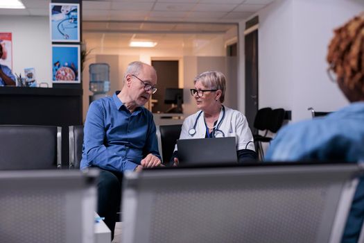 Physician using laptop at checkup visit
