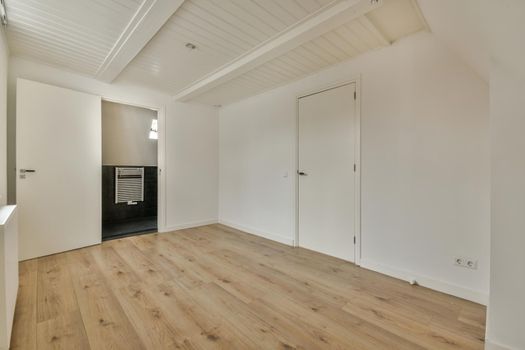Attic empty room with white walls and parquet floor