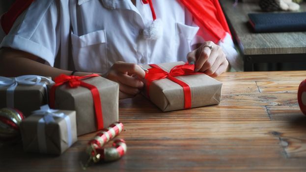 Woman preparing for Christmas and wrapping presents.
