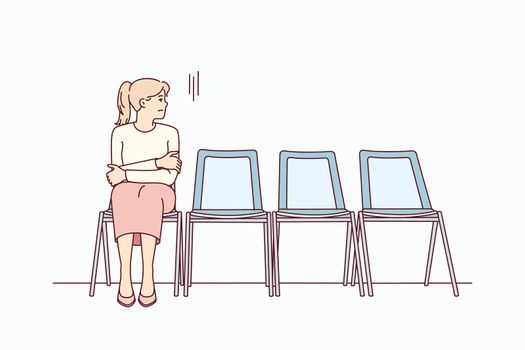 Anxious woman sit in chair waiting for appointment