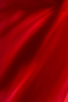 Red abstract art background, silk texture and wave lines in motion for classic luxury design