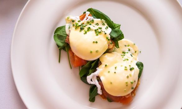 Luxury breakfast, brunch and food recipe, poached eggs with salmon and greens on gluten-free toast for restaurant menu and gastronomy