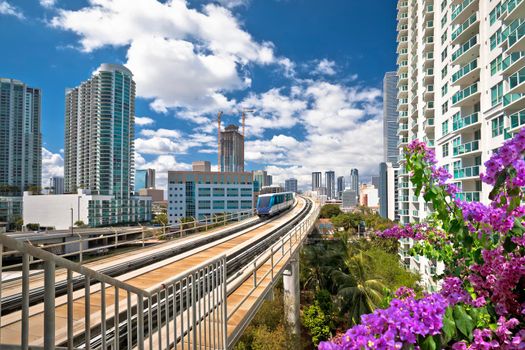 Miami downtown skyline and futuristic mover train colorful view