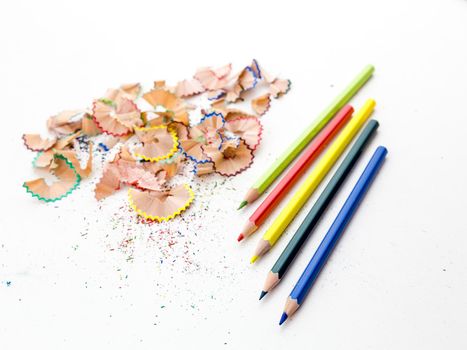 Colored pencil crayons in a row with shavings