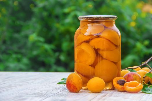 Preserved home-made apricots in jars. Selective focus.