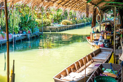 Local peoples sell fruits, food and souvenirs at floating market famous tourist attraction in Thailand