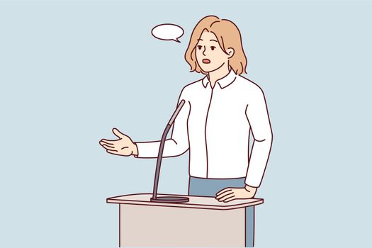 Businesswoman speak in microphone at conference