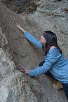 young woman rock climbing