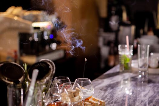 Aromatic smoke sticks on bar counter