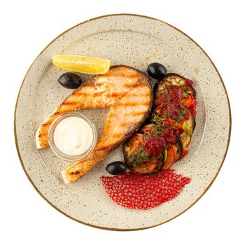 Plate of grilled salmon steak with aubergine