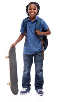 Skateboarding fun. A young African-American boy wearing a backpack and holding a skateboard.