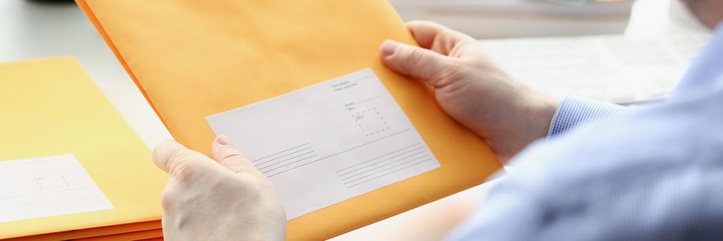 Man hold envelope, prepare package to give to courier for further delivery