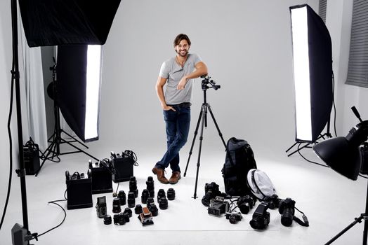 Professional studio photography. A professional photographer in his studio surrounded by equipment.