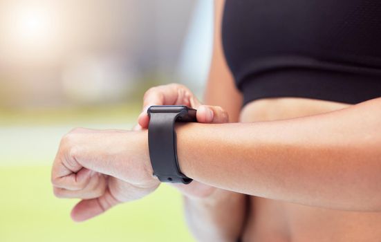 Smartwatch on hands of runner to track woman running time, health stats and train for competition race. Smart watches help competitive performance, motivate and inspire athlete to improve record time