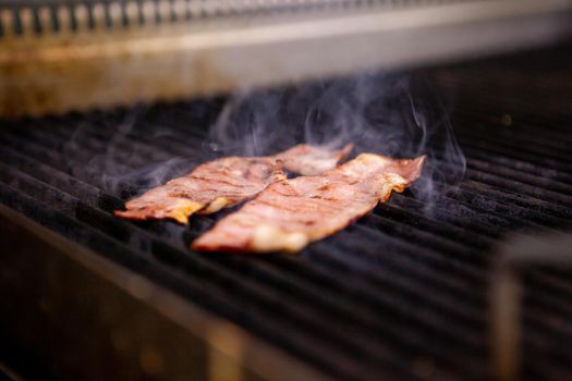 Delicious smoked bacon on grill in kitchen restaurant