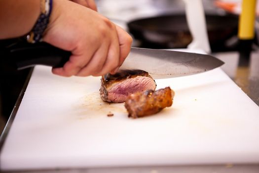 Chef slicing perfect cooked duck breast