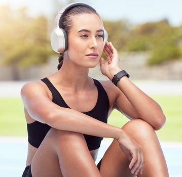 Relax, fitness and runner with headphone music for outdoor sports leisure and rest break. Wellness, motivation and workout woman enjoying rest time with audio technology streaming device.