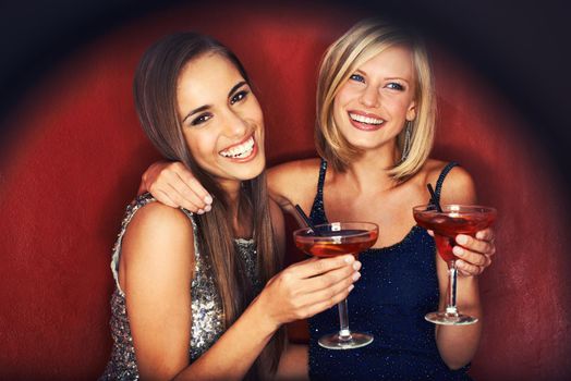 Girls night out. Two gorgeous young woman enjoying cocktails.