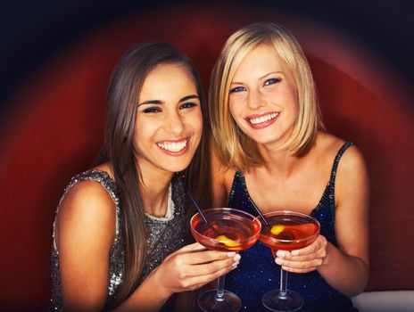 Girls only night out. Two gorgeous young woman enjoying cocktails.