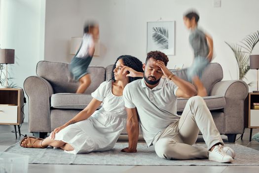Stress, tired and parents with adhd kids playing on couch making mom sad, exhausted and frustrated with dad. Headache, mother and overwhelmed father with loud children jumping on sofa in family home