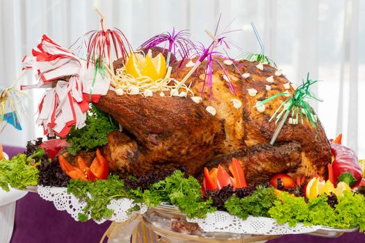 A large roast turkey on the holiday table at Thanksgiving.