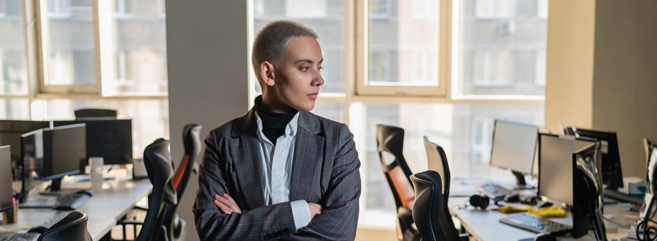 Business woman with short haircut in empty office.