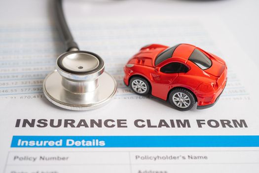 Stethoscope on Insurance claim accident car form, Car loan, insurance and leasing time concepts.