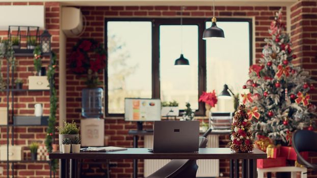 Festive decorated workplace with laptop on desk