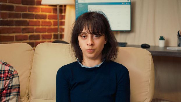 Portrait of displeased wife doing counseling session with therapist
