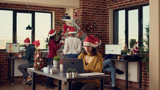 Diverse team of colleagues analyzing data in festive office