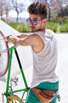 Watch this. Cropped portrait of a young man riding his bicycle.