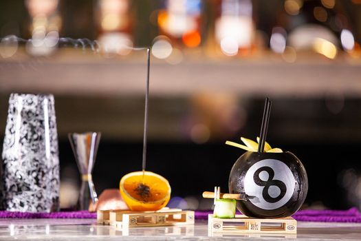 Cocktail in a pool bal on a bar counter