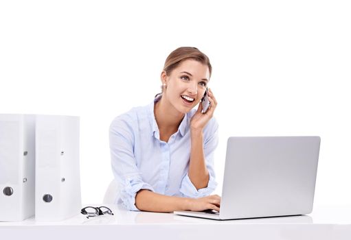 Contacting colleagues and clients. An attractive young businesswoman talking on her cellphone and surfing the net.