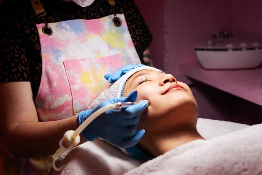 woman receiving an exfoliating facial treatment