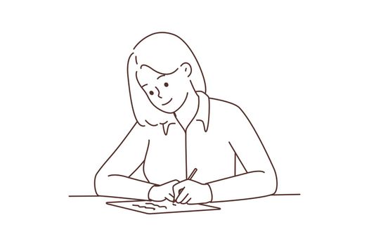 Smiling woman sit at desk writing