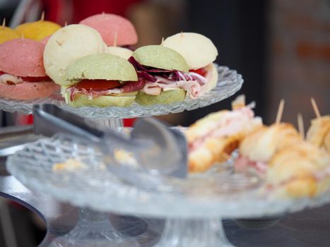 sandwiches, salty croissants and delicatessen finger food in a banqueting buffet